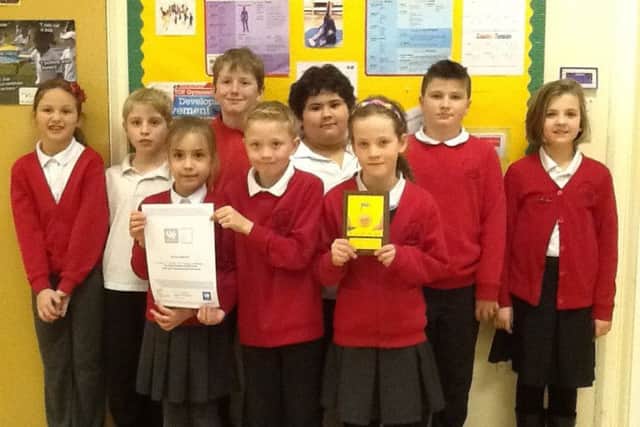 Pupils holding their School Games Gold Mark and Youth Sport Trust Silver Quality Mark awards. EMN-170213-103516001 EMN-170213-103516001