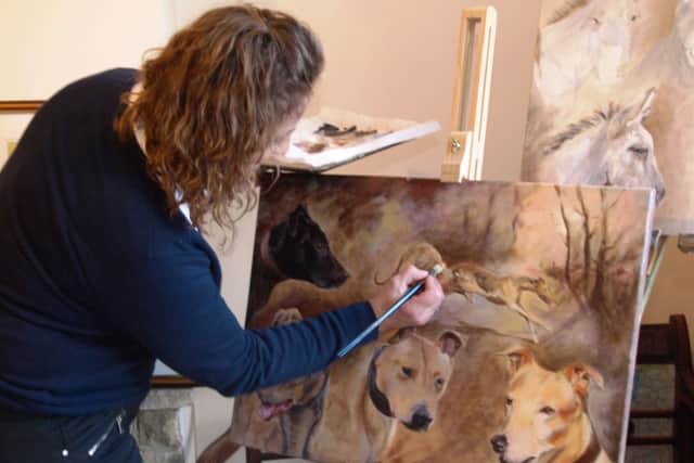 Angela Watson pictured at home working on one of her latest paintings.