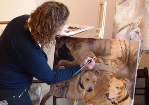 Angela Watson pictured at home working on one of her latest paintings.