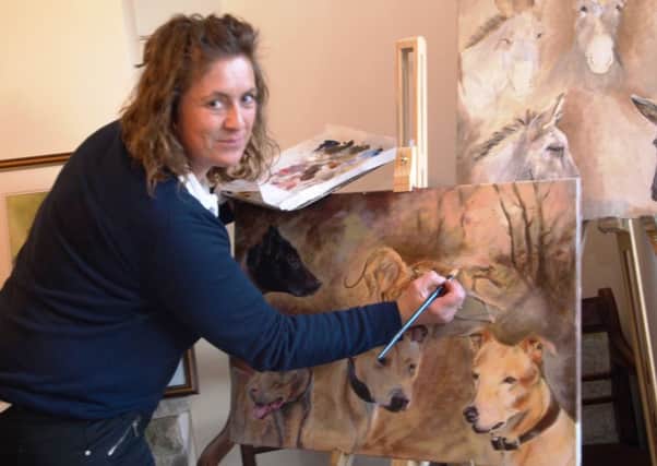 Angela Watson pictured working on one of her newest pieces of artwork at home.