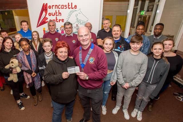 Steven Flood from Horncastle Lions hands over a cheque to Viv Cross at the opening night of the youth club