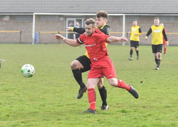 Goalscorer Jamie Elston chases Coningsby's Scott Trestrail.