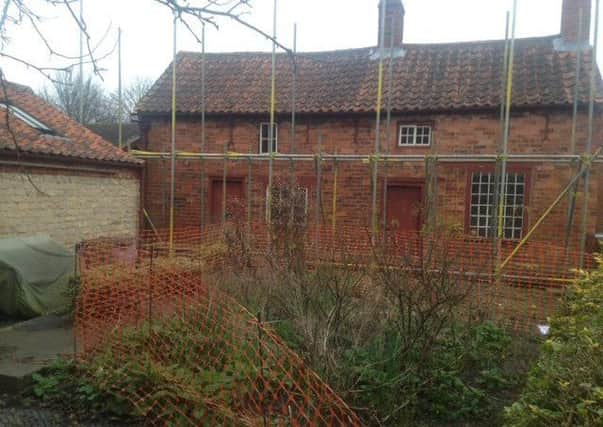 Scaffolding goes up on Mrs Smith's Cottage at Navenby. EMN-170228-120414001
