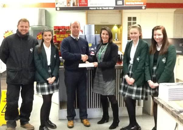 Howdens Joinery Company presenting the cheque to Mrs Pankhurst, head of technology pictured with pupils. EMN-170227-154254001
