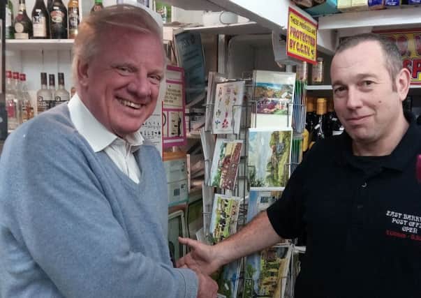 Sir Edward Leigh with Sub-Postmaster David Ward on his visit to East Barkwith Post Office EMN-170221-085451001