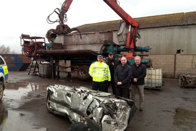 Assistant Chief Constable Paul Gibson, PCC Marc Jones and Deputy PCC Stuart Tweedale along with officers working on Operation Galileo with the crushed 4x4. EMN-170223-131813001