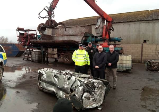 Assistant Chief Constable Paul Gibson, PCC Marc Jones and Deputy PCC Stuart Tweedale along with officers working on Operation Galileo with the crushed 4x4. EMN-170223-131813001