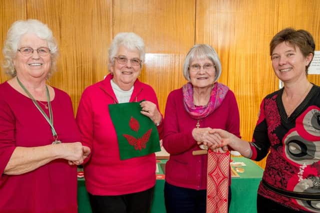 Winners of the red lace competition - Trish Miles, centre left, and Janet Sutton EMN-170227-133631001
