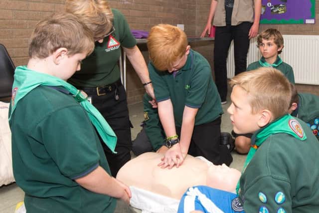 Scouts taking part in CPR training with a representatives from LIVES.