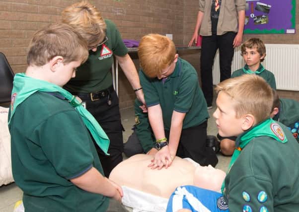 Scouts taking part in CPR training with a representatives from LIVES.