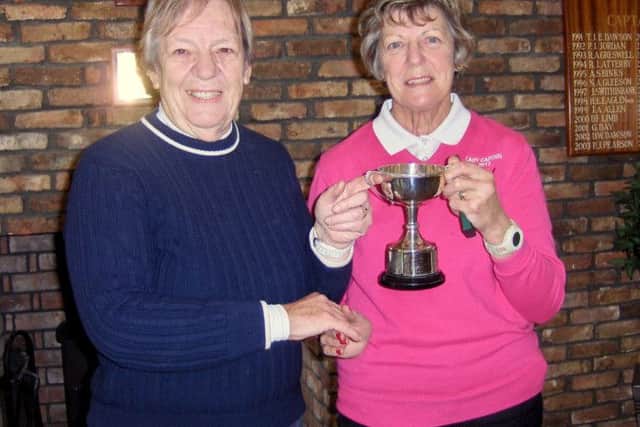 Kathleen Yates is seen receiving her trophy from Jean Markham.