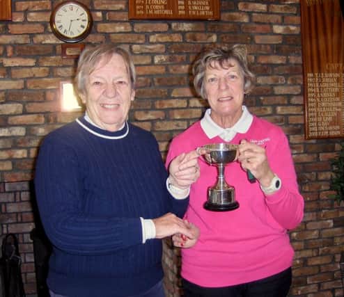 Kathleen Yates is seen receiving her trophy from Jean Markham.