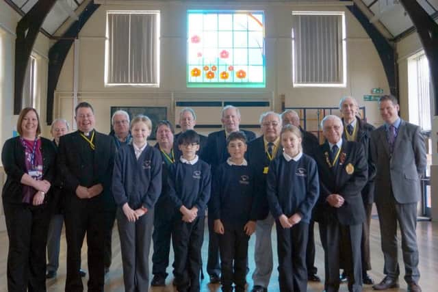 The Ven Mark Steadman, second left, with staff, governers, pupils and members of the Royal British LegionEMN-171203-214057001