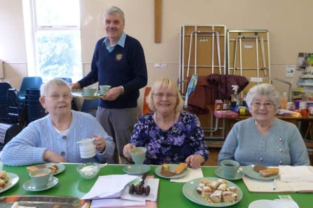 Lion Terry Box serving cups of tea to committee members left Jean Field, Chairman June Gaughan and Treasurer Eileen Burnett. (Photo by Linda Oxley) EMN-170803-114758001