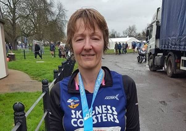 Carole Tumber with her medal after the Cambridge Half Marathon.