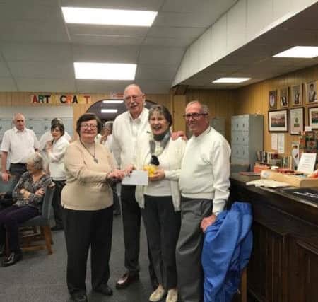 Ken Argent, Jacquie Thomas and Paul Thomas being presented with their prize by club treasurer Trisha Scholey.
