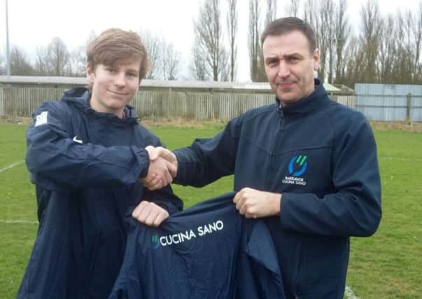 Saints skipper Matthew Dickens is pictured receiving the clubs new rain jackets.
