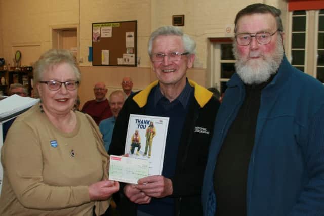Joe Gibson of Caistor Male Voice Choir (centre) presents a cheque to Margaret and Graham Smith of Caistor RNLI. EMN-170903-083214001