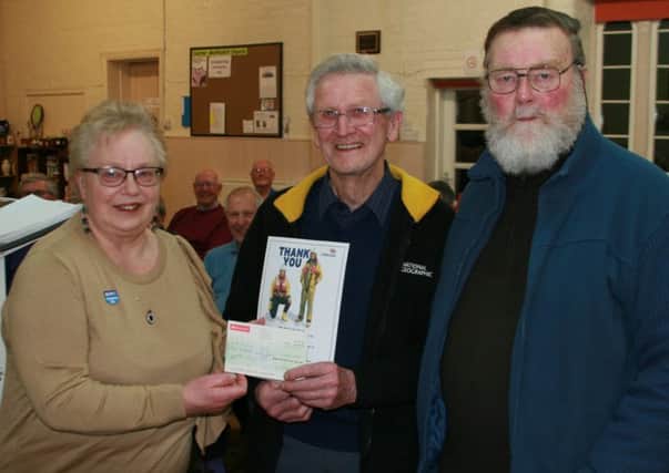 Joe Gibson of Caistor Male Voice Choir (centre) presents a cheque to Margaret and Graham Smith of Caistor RNLI. EMN-170903-083214001