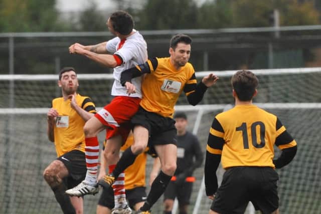 Market Rasen Town skipper Joe Osbourne in the thick of the action against Skegness EMN-170313-110912002