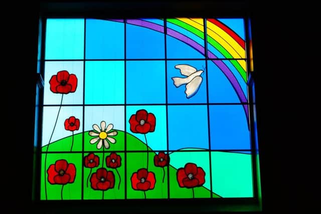 The stained glass window includes a single daisy in remembrance of pupil Claudia Burkill EMN-171203-214110001