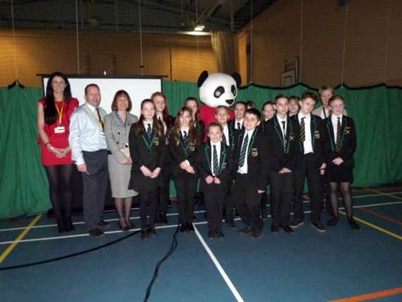 CYA Pupils with, left, branch manager of Education Network Linda Wright, Senior Education Consultant Lee Smith, Leader of Student Safety Julia Graham and, right deputy headteacher Jenny Rogers , together with Buddy the Panda. (photo by Linda Oxley) EMN-171003-084123001