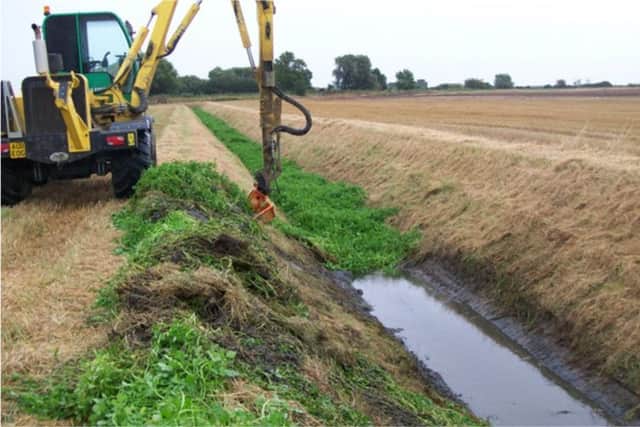 Maintenance of a smaller fen drain to remove weed growth and return the drain to its original design standard.