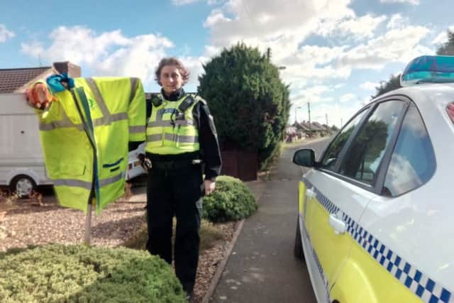 PC Sally West with a scarecrow wearing a hi-vis jacket placed in a residents garden to raise awareness about the dangers of speeding. ANL-171003-150716001