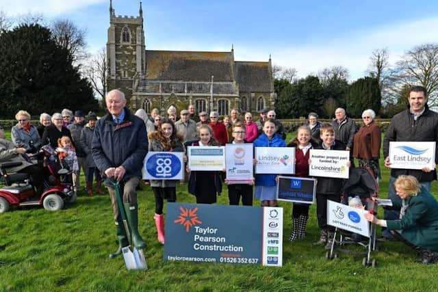 John Ellwood with local schoolchidren and residents at the turf cutting. Photo: John Aron