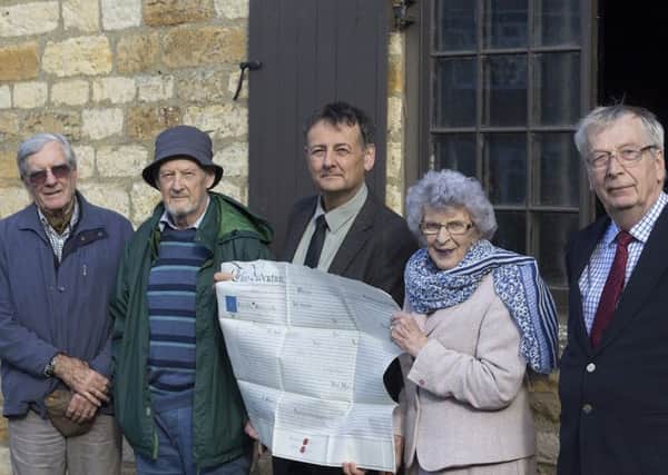 Staunch supporter of heritage in the district, Coun Marion Brighton, with members of Welbourn Parish Council and the deeds for Welbourn Forge. EMN-170313-141838001