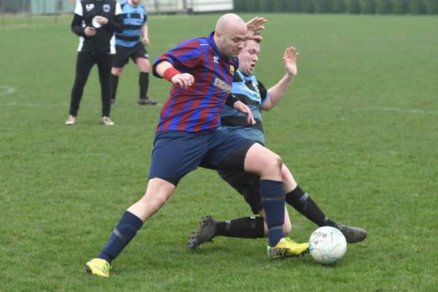 Northgate Olympic's Neil Wheskey (red/blue) tussles with Leverton's Ashley Bond EMN-170313-182259002