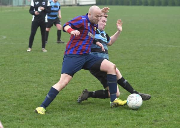 Northgate Olympic's Neil Wheskey (red/blue) tussles with Leverton's Ashley Bond EMN-170313-182259002