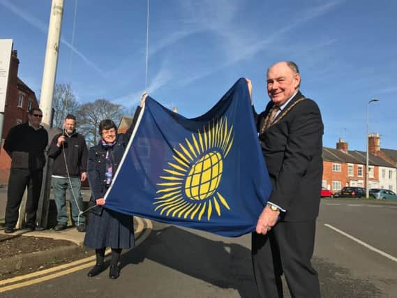 NKDC chairman Coun John Money and vice-chairman Coun Sally Tarry raise the flag for Commonwealth Day. EMN-170313-195504001