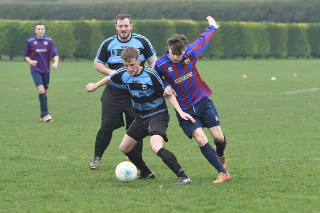 Leverton Reserves' Jack Mitchell in action with Northgate's Mark Davis. Photo: David Dawson.
