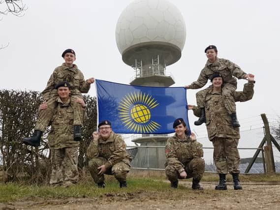 Pictured with the Commonwealth Flag are Corporal Chris Myburgh, Corporal Tom Meads, Lance Corporal Izzy Deans, Lance Corporal Jack Newrick, Cadet Izzy Keyworth and Cadet Elli Mutton EMN-170314-133546001