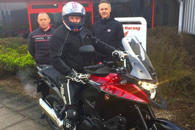 Kevin Skeith on his new bike with Rob Haines and Havier Beltran. EMN-170315-113638001