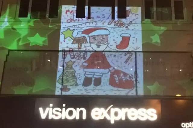 One of the community made projections used this Christmas. These were designed by residents of Boston, while another projection on the former Exchange building was designed professionally.