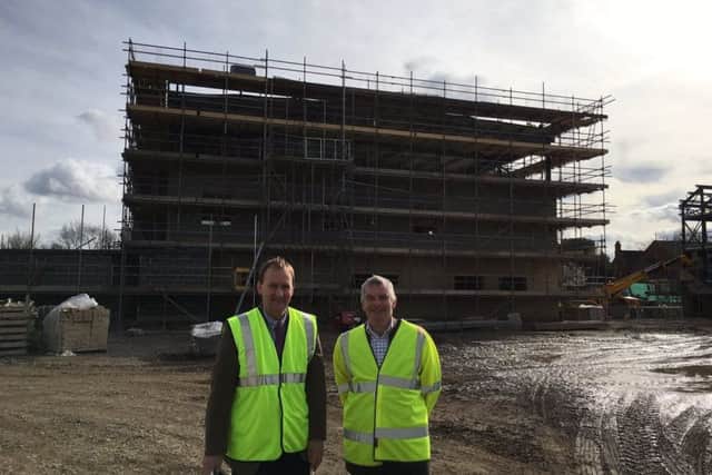 Leader of the County Council Martin Hill (right) with executive councillor Nick Worth, inspect the new Sleaford fire station taking shape. EMN-170320-195626001