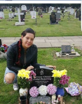 Serina Pickering by the grave of her baby daughter in St Mary's churchyard in St Mary's Churchyard in Winthorpe. ANL-170322-084434001