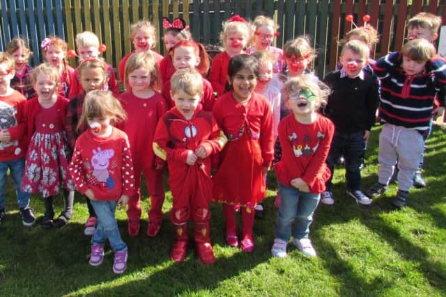 Reception pupils at Spilsby Primary School turned up this morning proudly dressed in red and made a donation to Comic Relief. ANL-170324-122430001