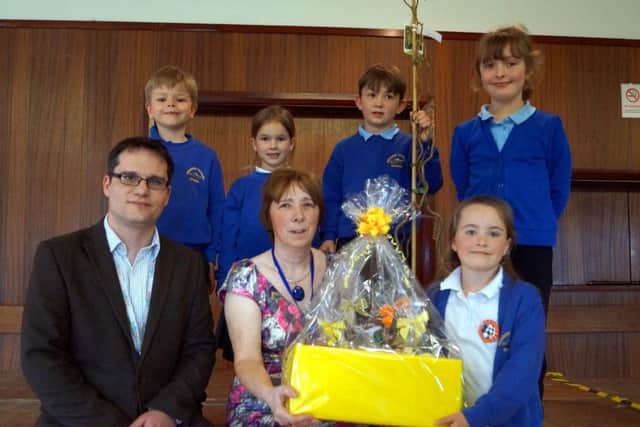 Osgodby headteacher Jill Fincham received a number of gifts on her retirement. She is pictured with chair of governors Matthew Head and some of the members of the school council EMN-170304-092215001