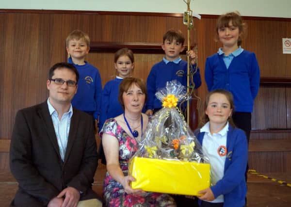 Osgodby headteacher Jill Fincham received a number of gifts on her retirement. She is pictured with chair of governors Matthew Head and some of the members of the school council EMN-170304-092215001