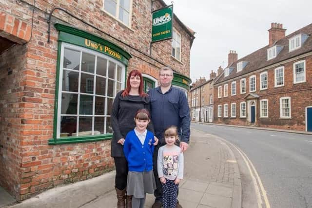 A family affair: Graham Midgely outside his new business with wife Naomi and children Olivia (6) and Rebekah (4)