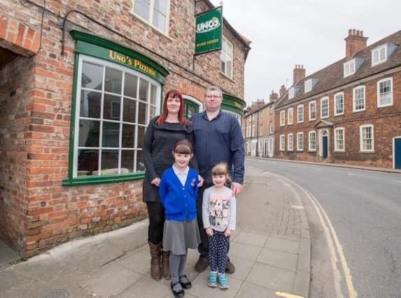 A family affair: Graham Midgely outside his new business with wife Naomi and children Olivia (6) and Rebekah (4)