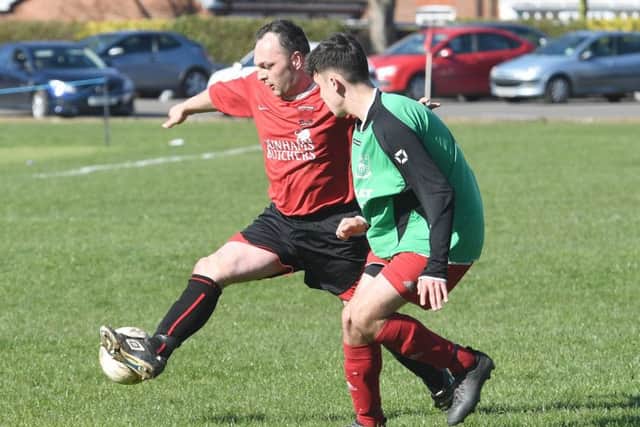 Billinghay's Scott Wiles keeps a close eye on Kirton's Darren Tate EMN-170328-092448002