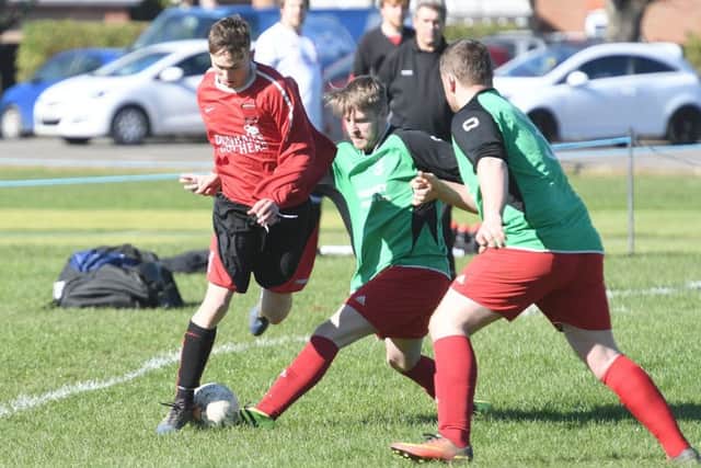 Billinghay Reserves' Jamie Green gets in a challenge on Kirton's Jack McCheeham in their 3-3 draw EMN-170328-092436002