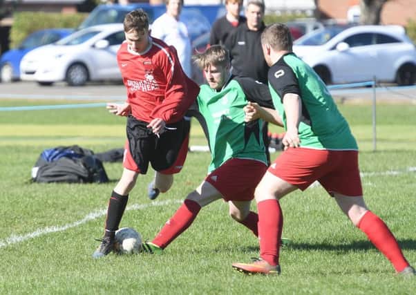 Billinghay Reserves' Jamie Green gets in a challenge on Kirton's Jack McCheeham in their 3-3 draw EMN-170328-092436002