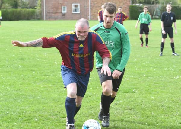 Steve Appleby and Ben Pollard challenge for the ball in Railway's contest against Fulbeck.