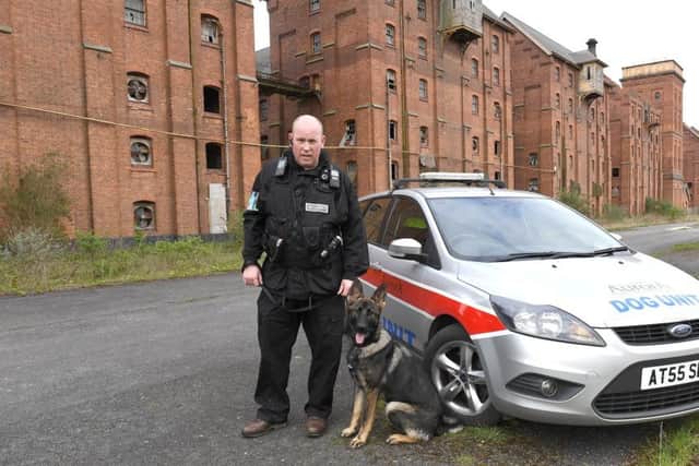 On patrol at the Maltings. Sam Maney of Aurora Security and security dog Gibbs. EMN-170404-100616001