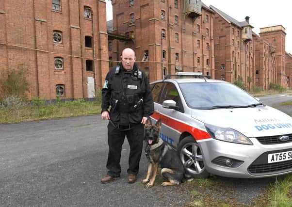 On patrol at the Maltings. Sam Maney of Aurora Security and security dog Gibbs. EMN-170404-100616001